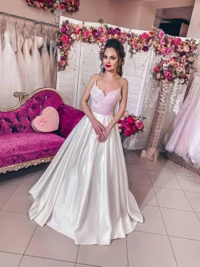 ---Wide satin wedding dress with an antique pink bodice sartorially draped and decorated with ivory lace, V-neckline with thin s